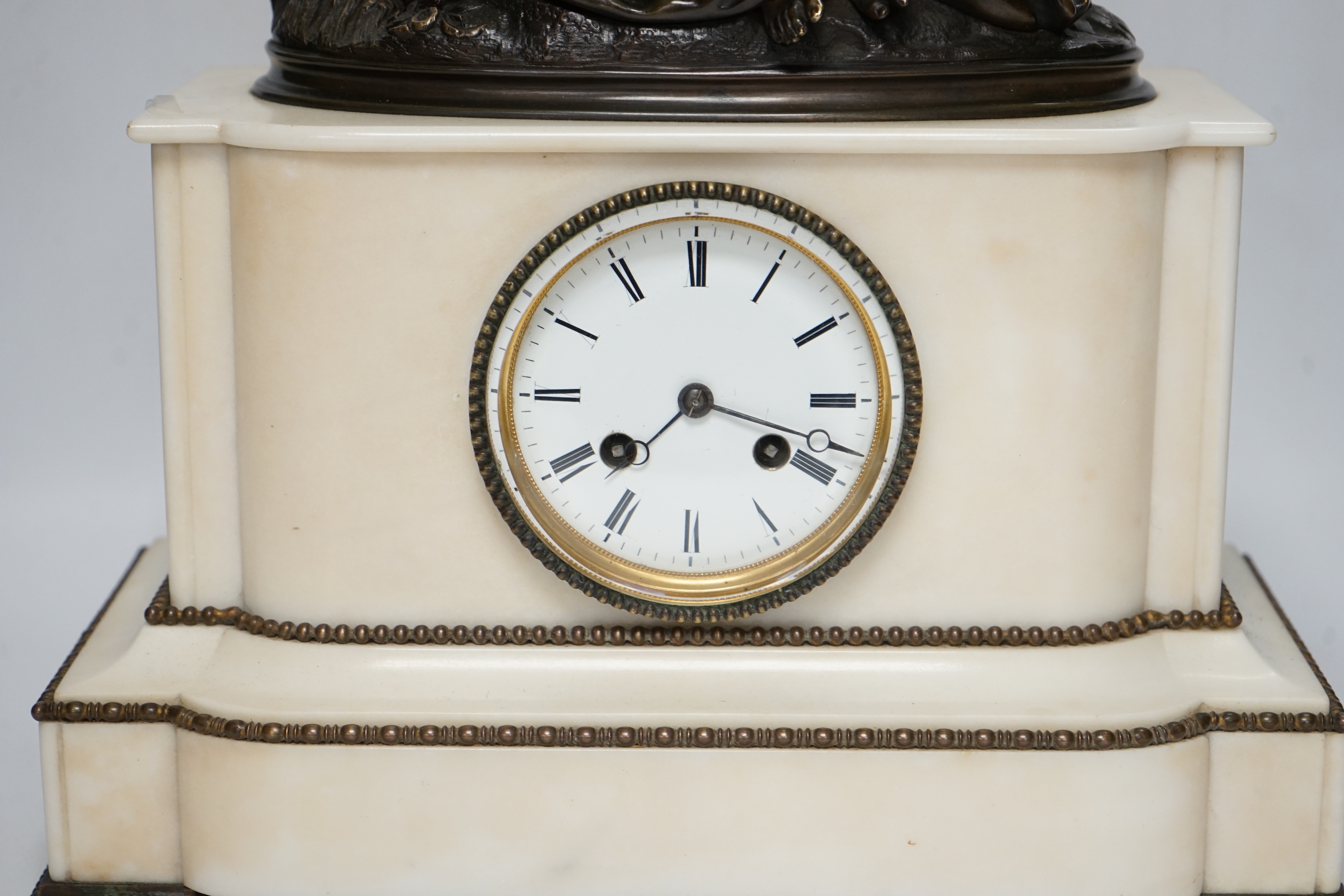 A late 19th century French figural bronze mounted white marble mantel clock, 42cm